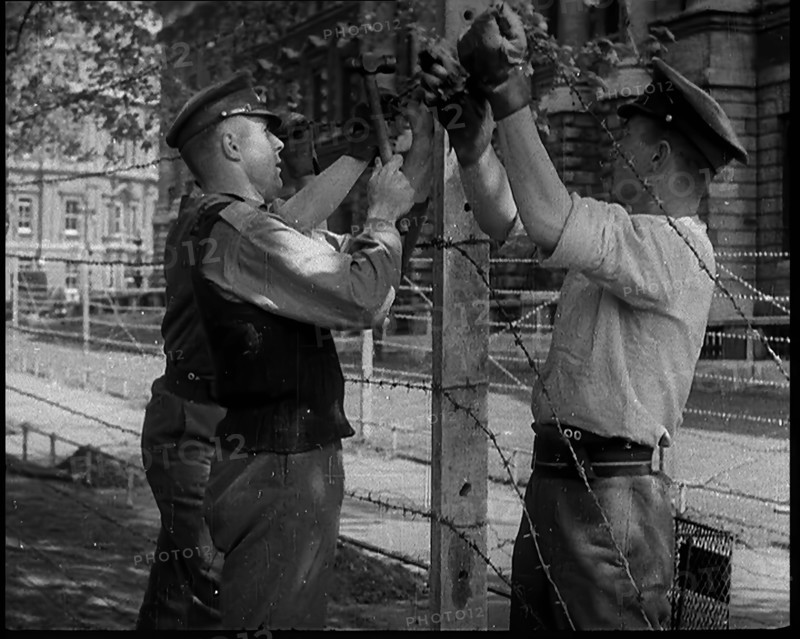 Three Men Setting up a Barbed Wire Fence, 1940. Creator: British Pathe Ltd.