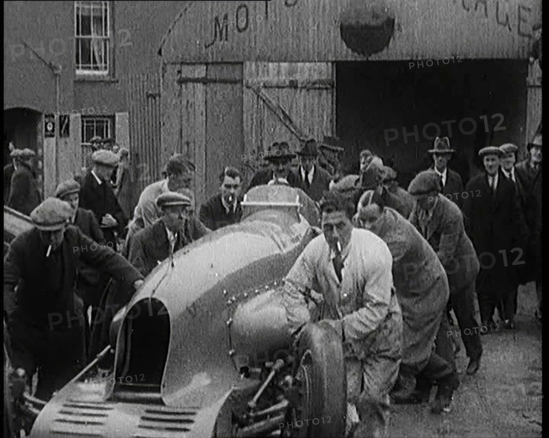 A Crowd of Civilians Watching a Group of Civilians Wheeling Malcolm Campbell's 'Bluebird'..., 1927. Creator: British Pathe Ltd.