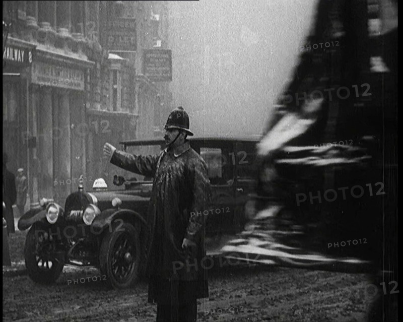A Male Police Officer Directing the Traffic in the Snow, Facing the Camera, 1920s. Creator: British Pathe Ltd.