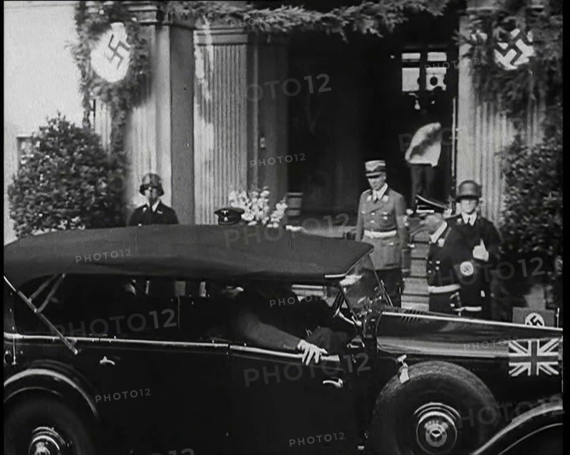 Adolf Hitler, the German Leader Coming Out of a Building in Bad Godesburg With Male German..., 1938. Creator: British Pathe Ltd.