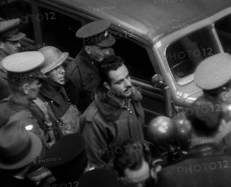 A Captured Italian Pilot Being Escorted Through a Train Station, 1940. Creator: British Pathe Ltd.