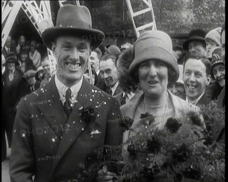 Male Civilian (Groom) And Female Civilian (Bride) Emerging from a Church To Walk Through an...,1920s Creator: British Pathe Ltd.