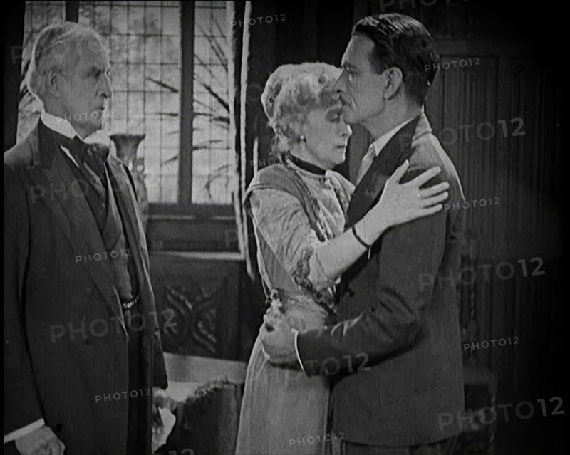 An Extract from a Silent Film. A Female Actor and a Male Actor Embrace. Another Male Actor..., 1920s Creator: British Pathe Ltd.