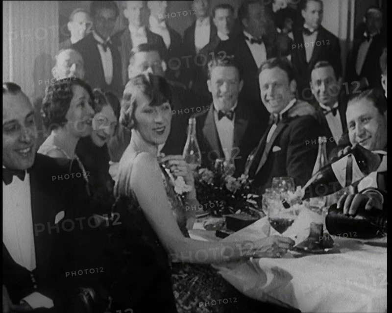 A Group of Fashionable Young People Sitting at a Table Drinking Champagne, 1924. Creator: British Pathe Ltd.