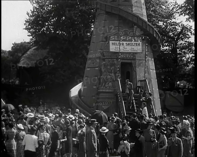 A Helter Skelter Fairground Ride in a Park With a Man at  the Entrance With a Megaphone..., 1939. Creator: British Pathe Ltd.
