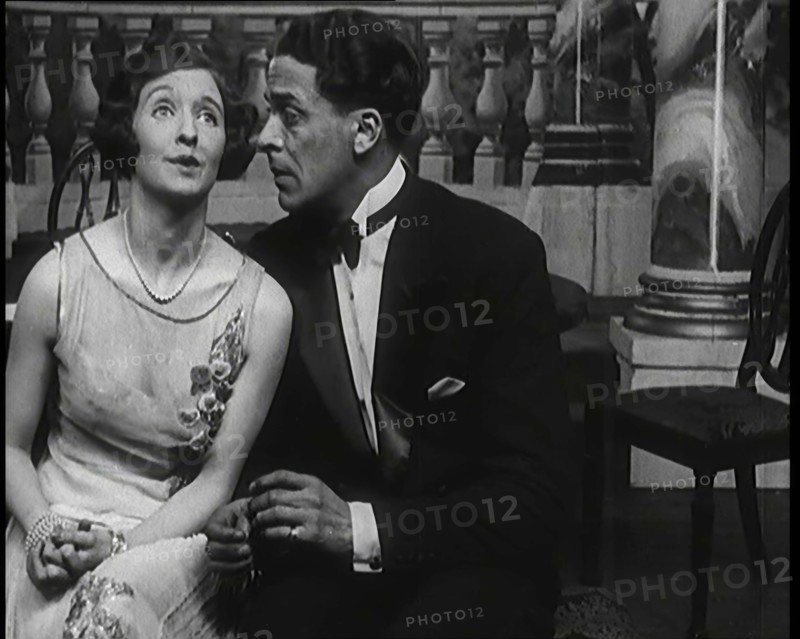 Jack Buchanan and June Knight Sitting on a Bench Together. Buchanan Looking Uncomfortable...,1920s Creator: British Pathe Ltd.