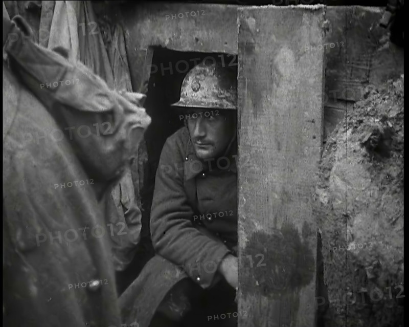 A Male French Soldier Sitting in a Doorway Dug into the Side of a Trench, 1939. Creator: British Pathe Ltd.