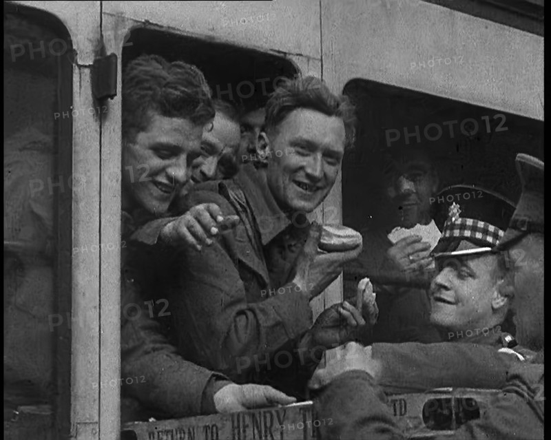 British Soldiers Receiving Food and Drink on the Train Back To Camp, 1940. Creator: British Pathe Ltd.