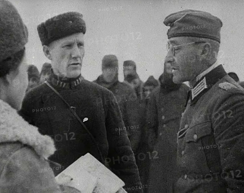 Two Russian Soldiers Talking to a German Prisoner of War, 1941. Creator: British Pathe Ltd.