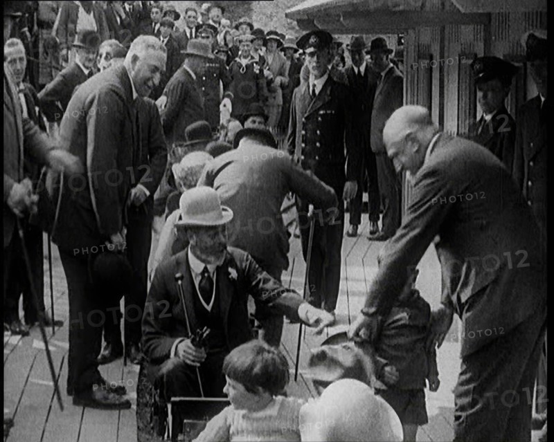 King George V of the United Kingdom Sitting On a Model Train With a Crowd of People Watching, 1924. Creator: British Pathe Ltd.