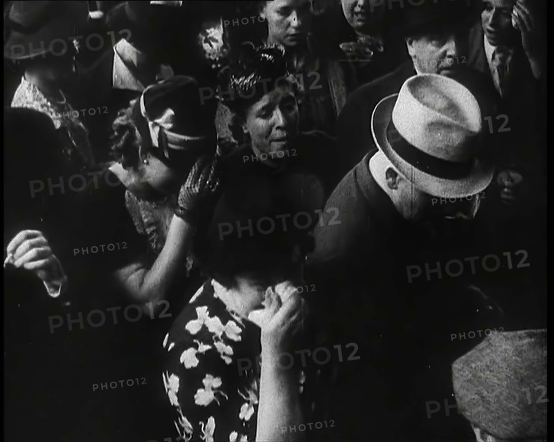 British Women and Men on a Crowded Railway Platform and Several Who Are Looking Upset, 1939. Creator: British Pathe Ltd.