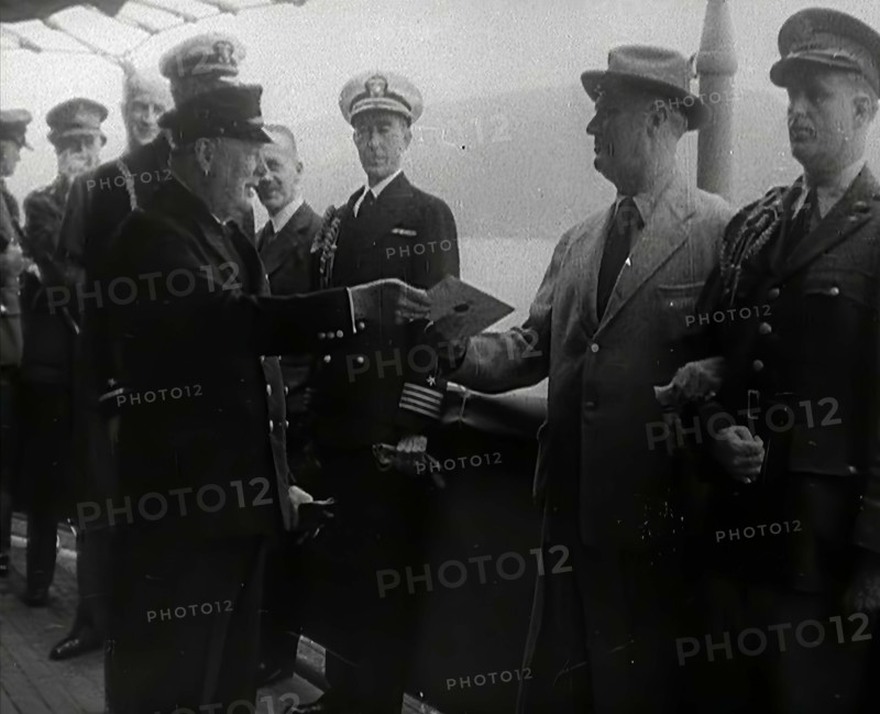 Winston Churchill Handing Franklin D. Roosevelt a Piece of Paper, 1941. Creator: British Pathe Ltd.