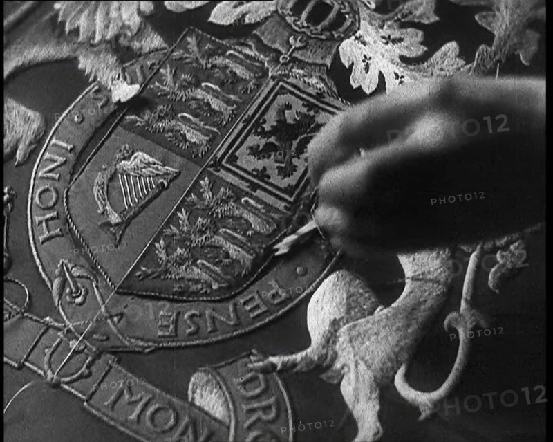 Hand of Seamstress Sewing a Royal Emblem, 1937. Creator: British Pathe Ltd.