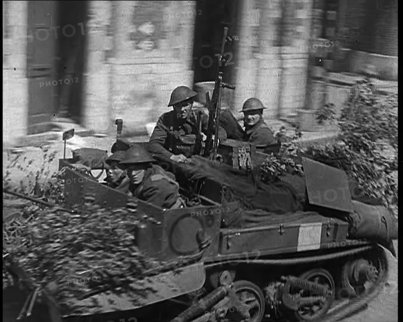 British Expeditionary Force Retreating Through Belgian Town on Vehicles, 1940. Creator: British Pathe Ltd.