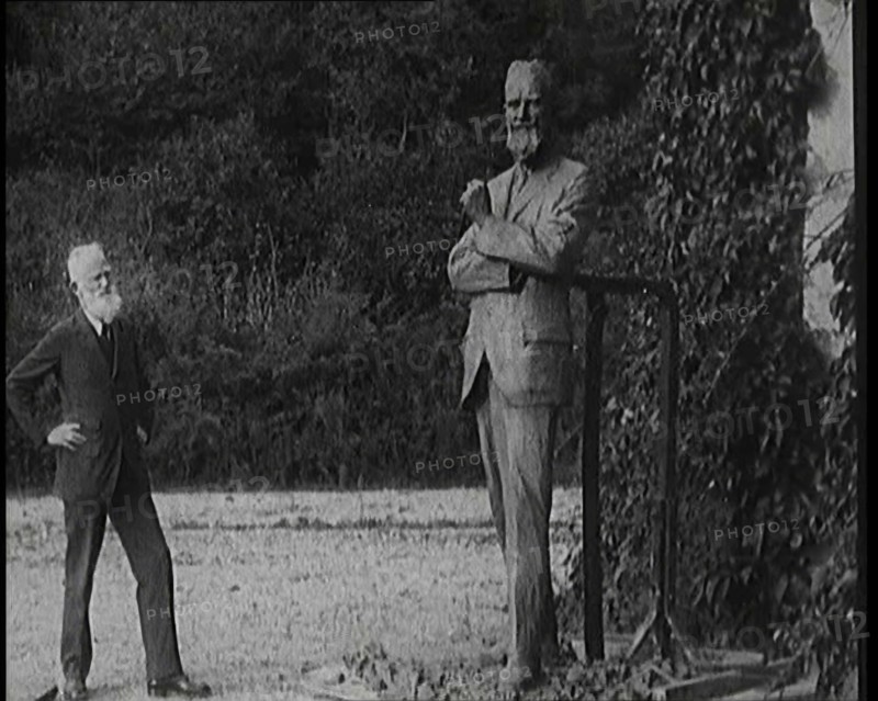 Playwright George Bernard Shaw Standing Next To a Statue of Himself, 1920s. Creator: British Pathe Ltd.