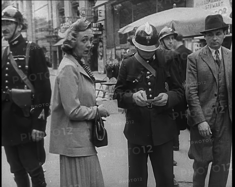 French Police Checking People's Papers Outside a Cafe in Paris, 1940. Creator: British Pathe Ltd.