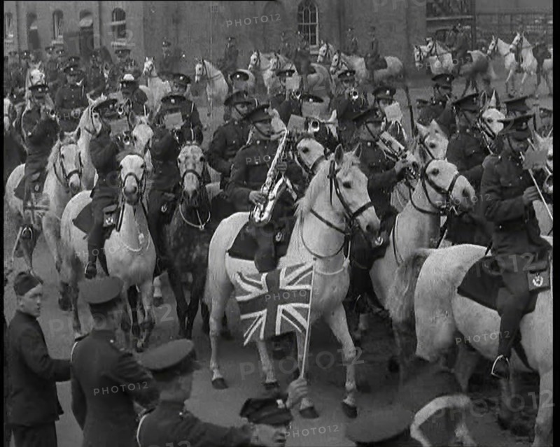 British Army Band on Horseback Parading Down a Street, 1937. Creator: British Pathe Ltd.