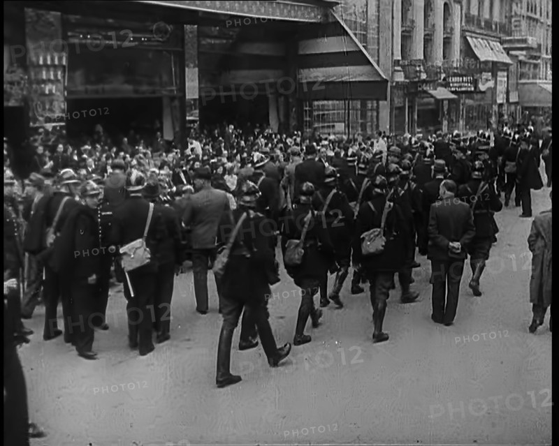 French Police Checking People's Papers Outside a Cafe in Paris, 1940. Creator: British Pathe Ltd.