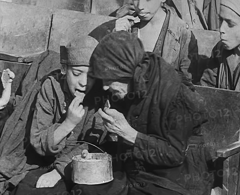 Italian Civilians Eating Food in a Bomb-Damaged Italian Town, 1943-1944. Creator: British Pathe Ltd.