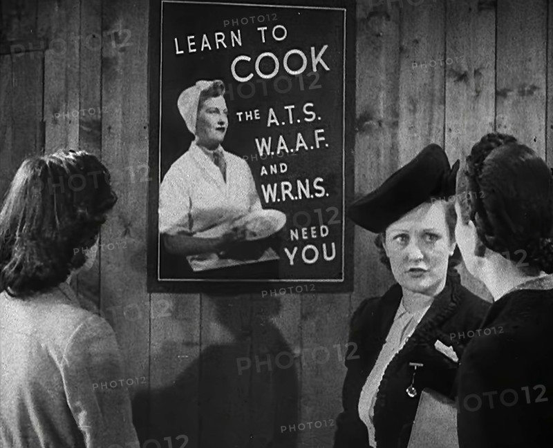 An Information Film Showing Women Looking at a Recruitment Poster for Female Army Cooks, 1942. Creator: British Pathe Ltd.