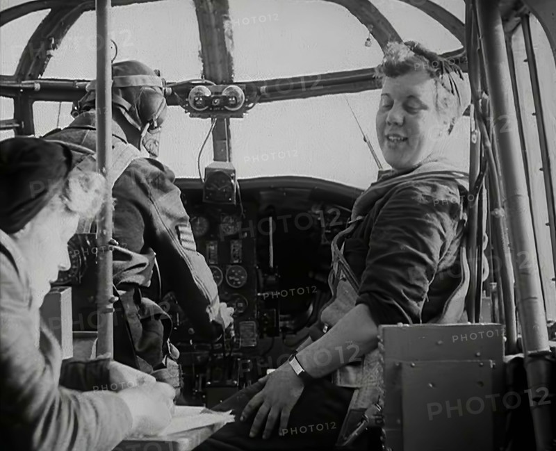 Women and a Pilot Sitting in the Cockpit of a Plane, 1942. Creator: British Pathe Ltd.
