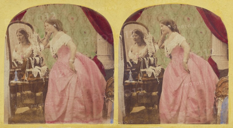 Woman admiring herself in the vanity, about 1860. Creator: Thomas Sutton.