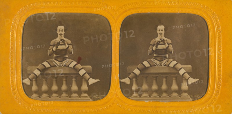 Harlequin playing a small flute, 1860s. Creator: E Lamy.