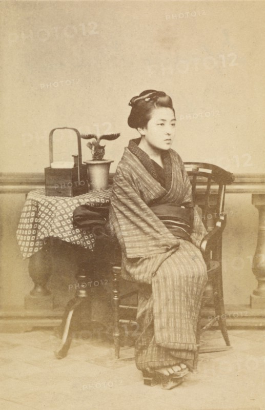 Woman sitting by table, about 1868. Creator: Felice Beato.
