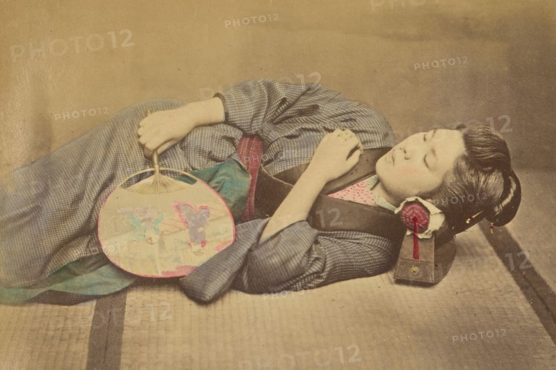 Sleeping Japanese woman holding a fan, 1868-1880. Creator: Felice Beato.