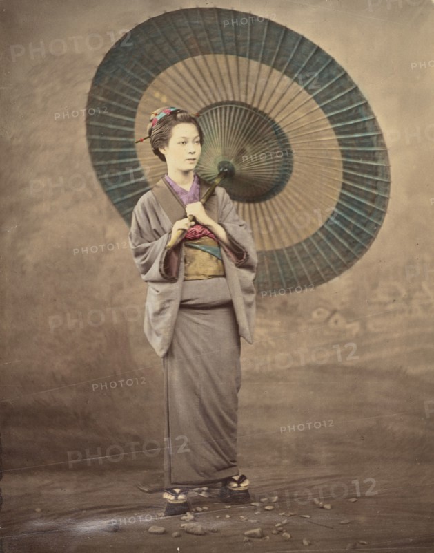 Japanese woman holding a large parasol, 1868-1880. Creator: Felice Beato.