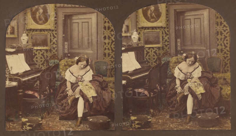 Innocence: woman seated in parlor fixing her shoe, about 1860. Creator: Unknown.