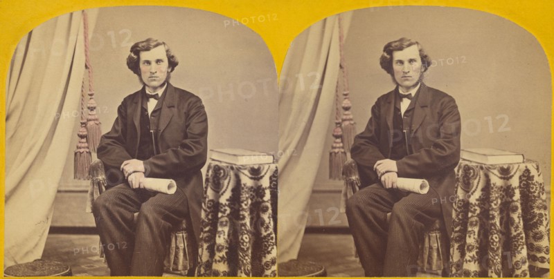 Unidentified man with muttonchops seated, holding a rolled paper, about 1860. Creator: Unknown.