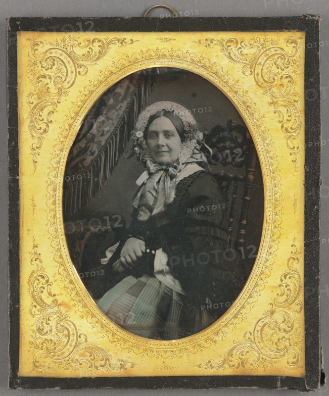 Portrait of a woman in bonnet, seated, about 1850. Creator: Unknown.