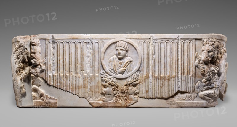 Front of a Sarcophagus with Female Portrait in a Medallion above Two Theatrical Masks...250-275. Creator: Unknown.
