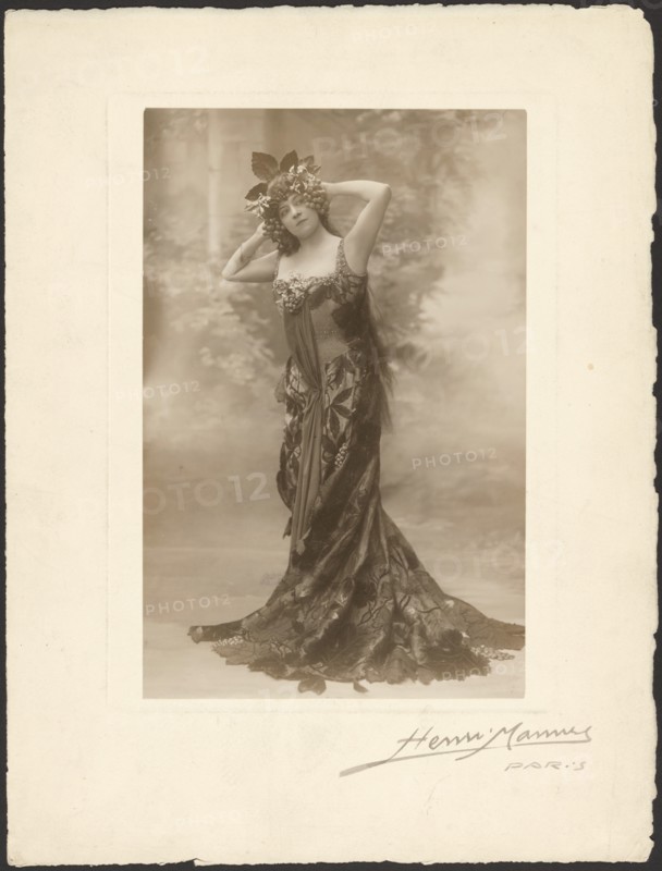 Woman wearing headdress with grapes, about 1890. Creator: Henri Mannes.