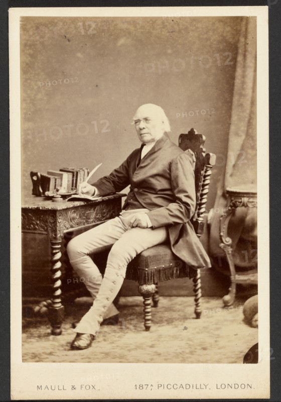 Portrait of man holding quill, about 1879-1885. Creator: Maull & Fox.