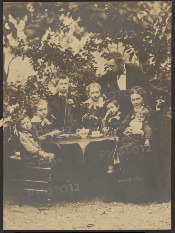 Group portrait around table, 1880-1890. Creator: Victor Dix.