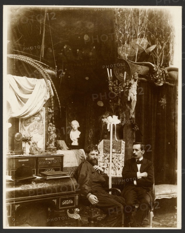 Self-Portrait with possibly Paul Gauguin in His Studio, Rue du Val-de-Grâce, Paris, neg 1899. Creator: Alphonse Mucha.