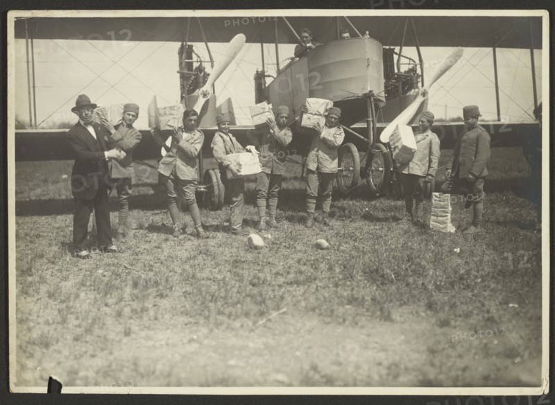 People loading supplies on airplane, 1919-1930. Creator: Fédèle Azari.
