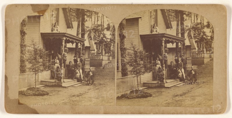 Family portrait posed on front porch of house, about 1865. Creator: Unknown.