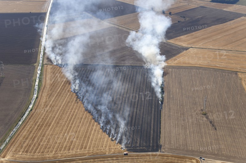 Fires in an arable field engulfing an electricty pylon, Amcotts, North Lincolnshire, 2022. Creator: Emma Trevarthen.