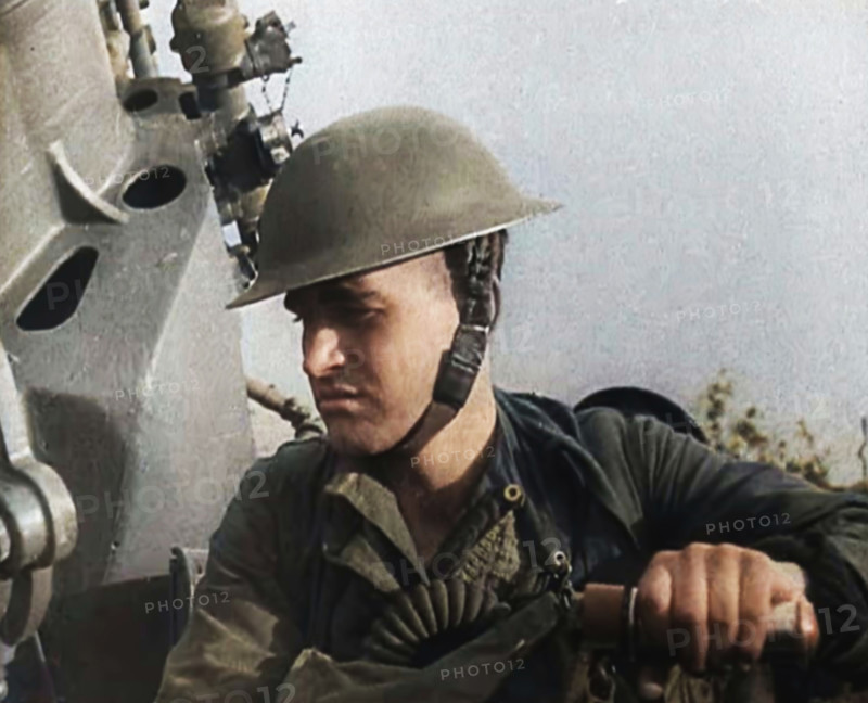 Close up of a Male British Soldier Wearing a Steel Helmet and Sitting Next to an Anti-Air..., 1939. Creator: British Pathe Ltd.