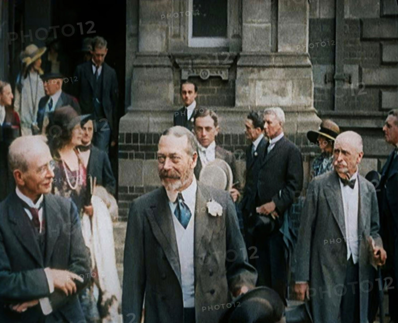 King George V Accompanied by a Group of Officials Emerging from a Building , 1924. Creator: British Pathe Ltd.