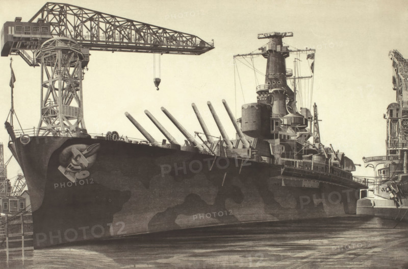 Battle Wagon - USS Alabama Outfitting at Norfolk Navy Yard Crane Ship Kearsarge Alongside, 1943. Creator: John Taylor Arms.