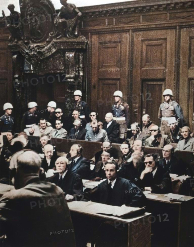 Nuremberg war crimes trial, Germany, 1946. Between 20 November 1945 and 1 October 1946 the 24 surviving most senior Nazi leaders were tried before the International Military Tribunal in the Palace of Justice in Nuremberg. The defendants pictured are as follows. Back row (left to right): Admiral Karl Doenitz, Admiral Erich Raeder, Baldur von Schirach (leader of the Hitler Youth), Fritz Sauckel (head of the Nazi slave labour programme), General Alfred Jodl, Franz von Papen. Front row (left to right): Hermann Goering, Rudolf Hess, Joachim von Joachim von Ribbentrop (Foreign Minister), Field Marshal Wilhelm Keitel, Alfred Rosenberg, Hans Frank (ruler of occupied Poland), Wilhelm Frick (Interior Minister). Von Papen was acquitted, Doenitz, Raeder, von Schirach and Hess received prison terms (the latter for life) and the remainder were sentenced to death. (Colorised black and white print).