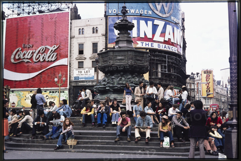 Crowds on the steps at the base of the Shaftesbury Memorial Fountain, or Eros, at Piccadilly Circus, London, 1974.