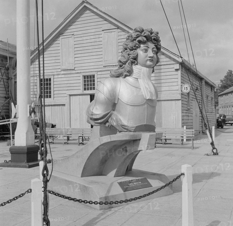 General view of a figurehead from HMS Benbow outside Boat House number 5 at Portsmouth Naval Dockyard, 1956.