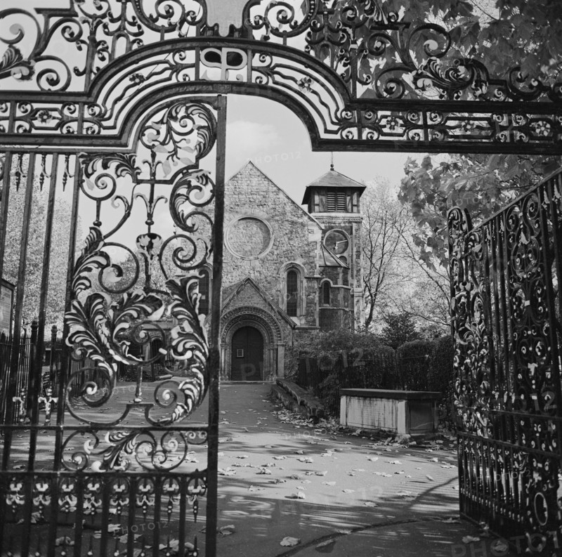 St Pancras Old Church viewed through the wrought iron gateway leading into St Pancras Gardens, London, 1960-1972.