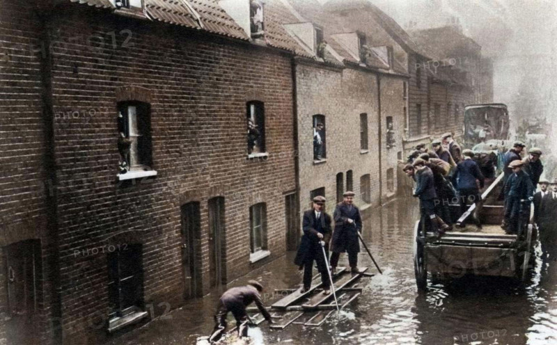 Flooding of London, January 1928 (1937). 14 people were killed when the Thames flooded in London on 6th-7th January 1928. A print from "The Story of Seventy Momentous Years, the Life and Times of King George V, 1865-1936", editor Harold Wheeler, Odhams Press Ltd, London, 1937. (Colorised black and white print).