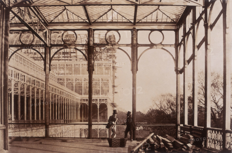 'Open Colonnade, Garden front', Crystal Palace, Sydenham, 1852-1854. Designed by Sir Joseph Paxton to house the Great Exhibition of 1851 in Hyde Park, the Crystal Palace was reconstructed and enlarged in Sydenham in 1852. The first column was raised on 5 August 1852 and the palace was opened by Queen Victoria on 10 June 1854. Many exhibitions and events were subsequently held at the Crystal Palace until it burnt down on 30 November 1936. The park contained a motor racing circuit from 1937 until 1972 and the famous athletics track dates back to the foundation of the Crystal Palace Athletics Club in 1868. Plate 34 from "Photographic Views of the Progress of the Crystal Palace, Sydenham. Taken during the progress of the works, by desire of the directors, by Philip H Delamotte. Together with a list of the directors and officers of the company, etc". [London, 1855].